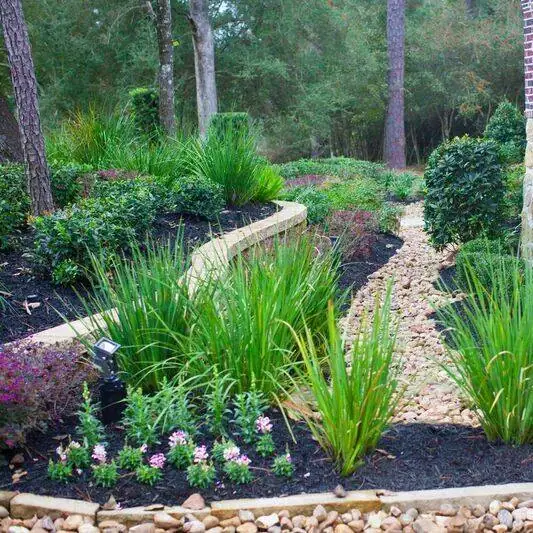 PGS-designed flower beds with stone pathway and curated plantings