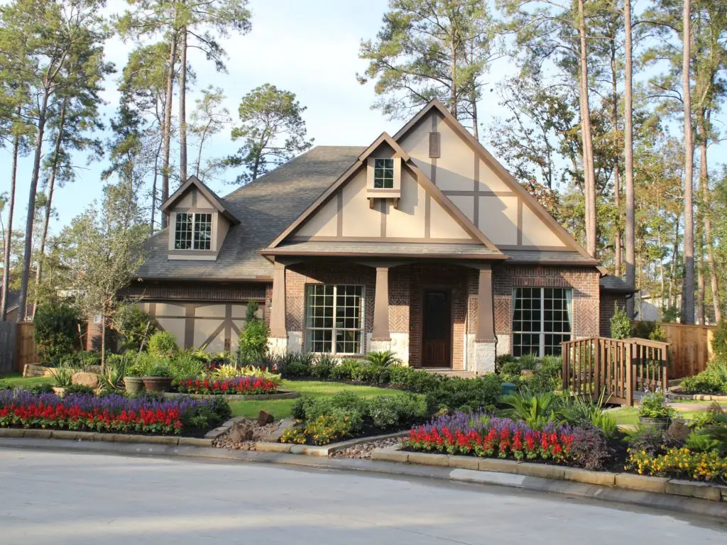 Custom residential landscape installed by PGS — Tudor home with manicured beds, color, and turf